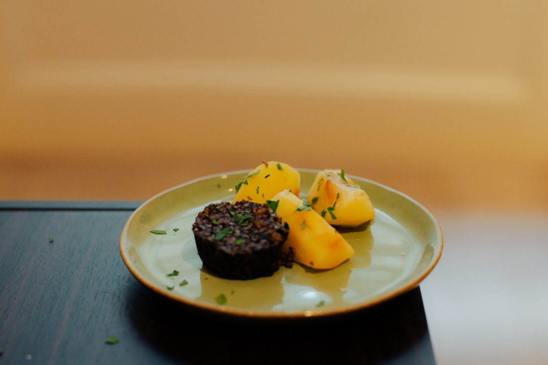 Morcilla with braised apple, plated