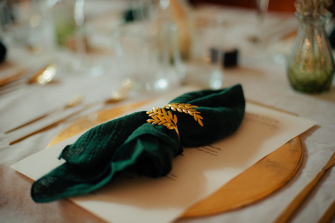 Green napkin with a gold wheat sprig