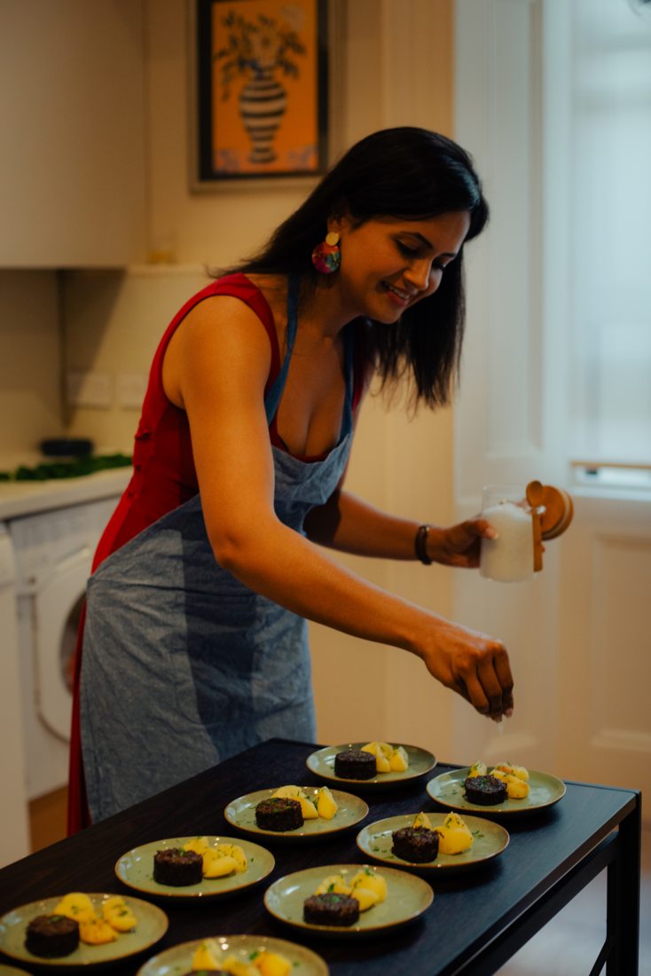 Ankita finishing plates in the kitchen