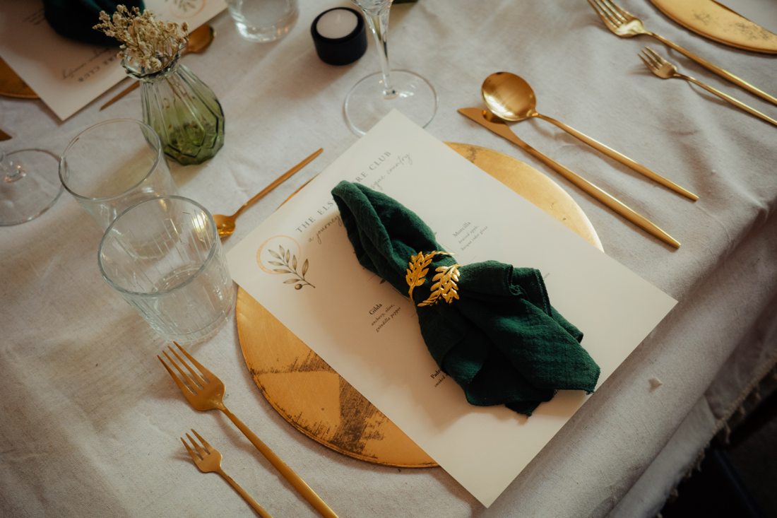 Place setting with menu and gold cutlery